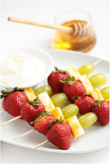 fruit kabobs with strawberries, melon, and grapes.