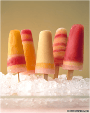 an assortment of homemade popsicles with fresh fruit.