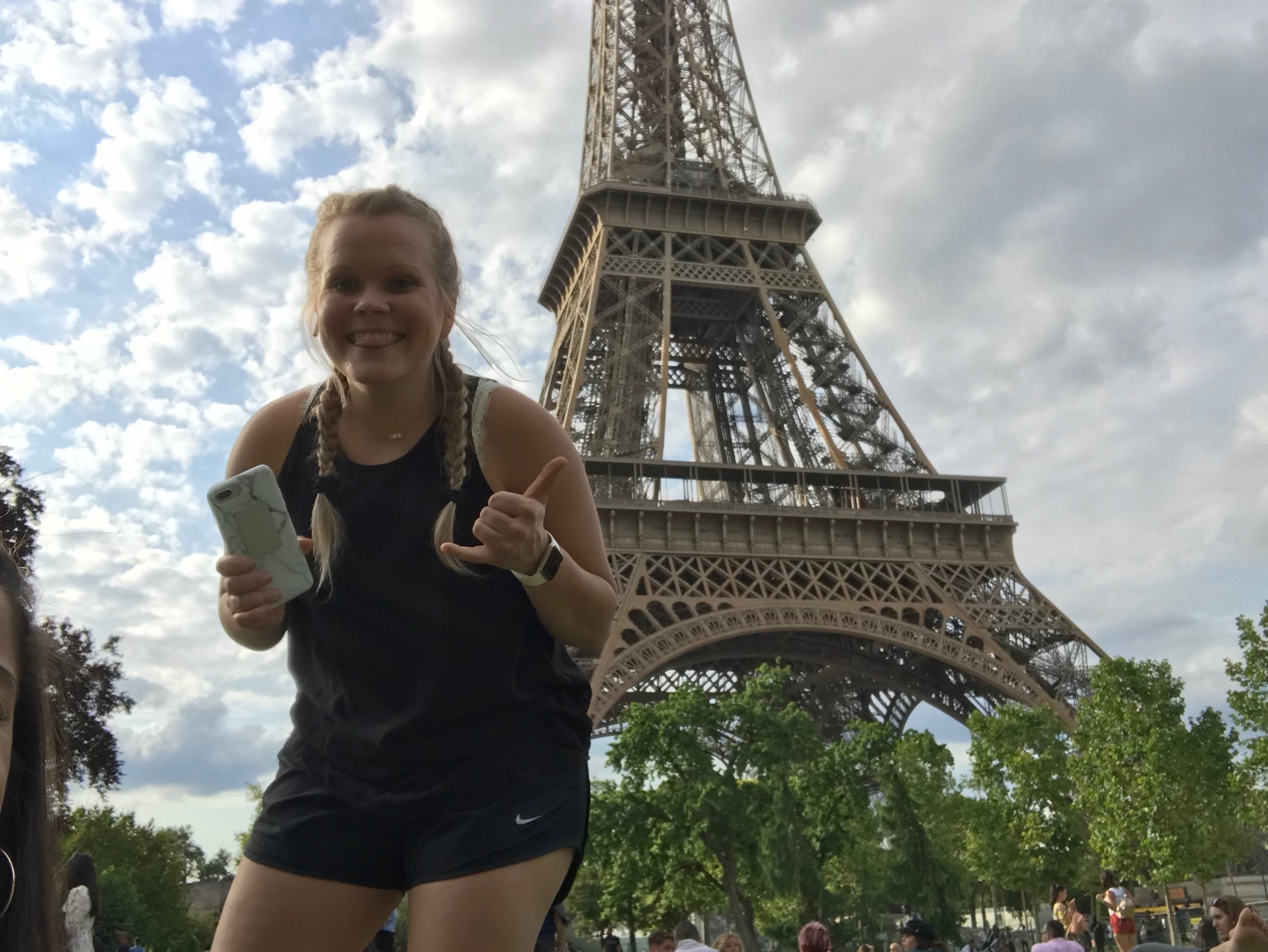 Girl running in front of the Eiffel Tower